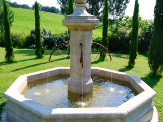 Fontaine centrale en pierre installée dans un jardin, Provence Retrouvée Provence Retrouvée 지중해스타일 정원