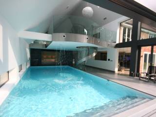 Indoor pool with waterfall features, sauna and stainless steel spa, Tanby Pools Tanby Pools Piscinas modernas