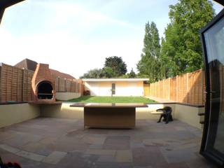 patio with raised sitting area and suspended brick barbecue Progressive Design London Modern Garden