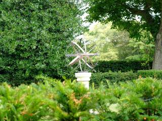 Verdigris armillary behind an evergreen hedge Border Sundials Ltd Classic style garden Accessories & decoration