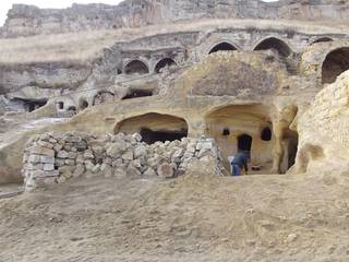 Muhittin Toker evi Öncesi ve Sonrası, Kayakapi Premium Caves - Cappadocia Kayakapi Premium Caves - Cappadocia Casas de estilo rústico