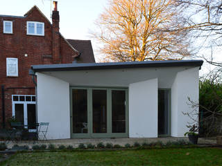 Rear view of the new single storey extension ArchitectureLIVE Modern houses extension,courtyard extension,single storey,green window frame,bifold doors,white render,zinc roof,butterfly roof,full height windows,patio