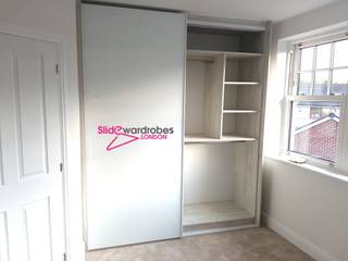 Floor to ceiling wardrobe with 2 sliding doors. Opened door view Slide Wardrobes London Minimalist bedroom Glass Wardrobes & closets