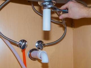 plumber repairing sink , Plumbers Network Durbanville Plumbers Network Durbanville Phòng tắm phong cách hiện đại