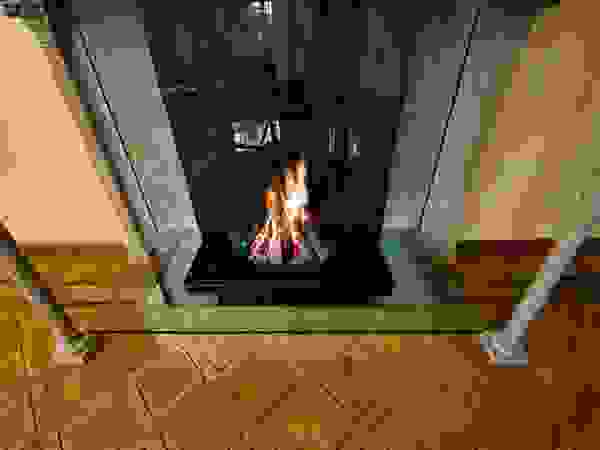Modern glass fireplace inside an original Italian style fireplace Bloch Design Living roomFireplaces & accessories