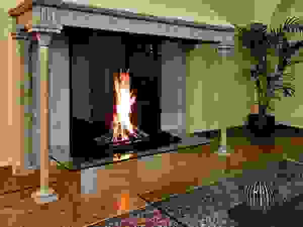 Modern glass fireplace inside an original Italian style fireplace Bloch Design Living roomFireplaces & accessories