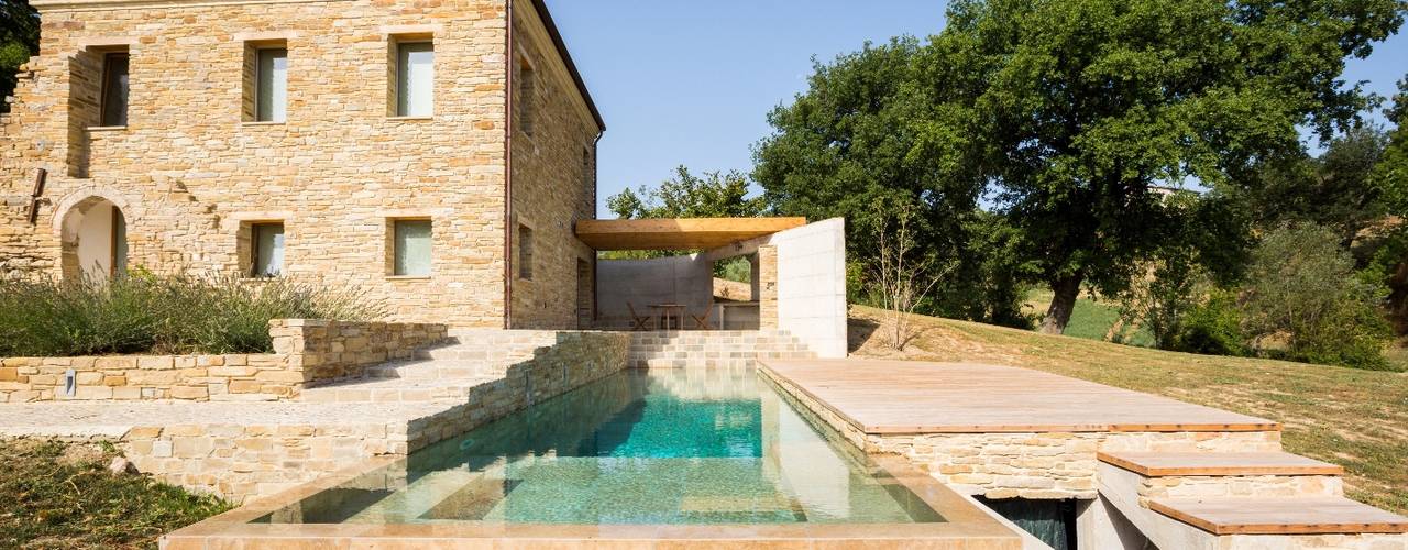 REALIZZAZIONE PISCINE CASTIGLIONE: IN UN CASALE NELLE COLLINE MARCHIGIANE, EDIFICIO, PISCINA E NATURA SI FONDONO IN UN TUTT’UNO PROGETTUALE DI GRANDE PREGIO, PISCINE CASTIGLIONE PISCINE CASTIGLIONE Piscina in stile rustico