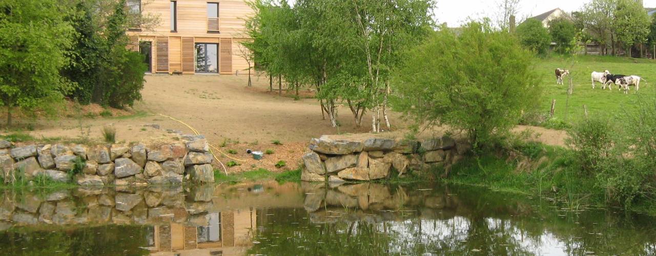 Maison bioclimatique près de l'étang à Mézières sur Couesnon, Catherine DANIEL Architecte Catherine DANIEL Architecte Modern houses