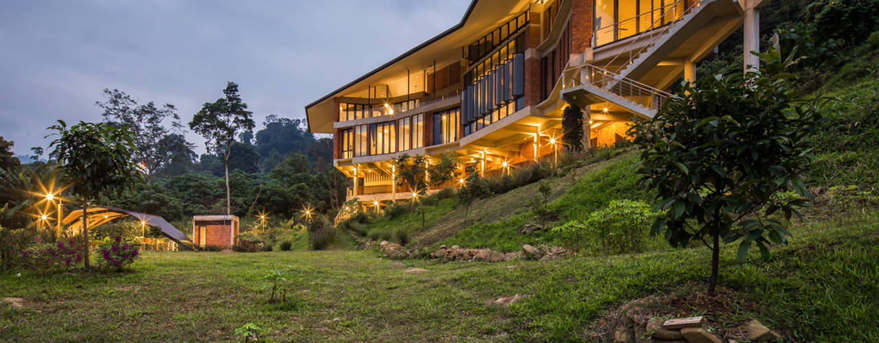 hillside house on stilts by TWO+ preserves natural surroundings