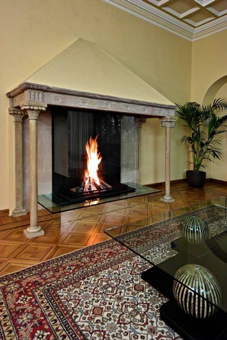 Modern glass fireplace inside an original Italian style fireplace Bloch Design Living roomFireplaces & accessories