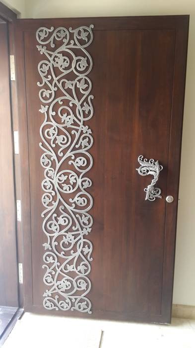 white metal applique on the main door homify Modern corridor, hallway & stairs Accessories & decoration