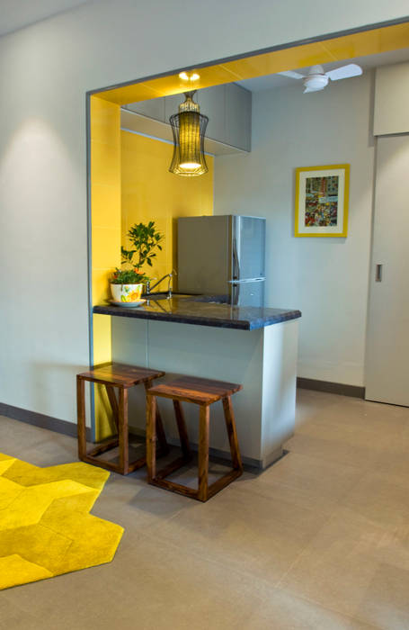 RESIDENCE AT CUFFE PARADE, Dhruva Samal & Associates Dhruva Samal & Associates Minimalist kitchen Building,Property,Table,Wood,Interior design,Yellow,House,Plant,Floor,Desk