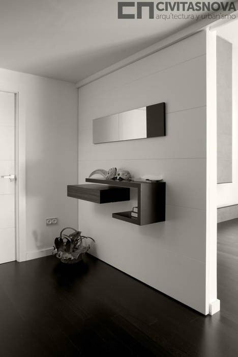 CIVITASNOVA - Vestíbulo: tabique corredero con mueble auxiliar CIVITASNOVA Pasillos, vestíbulos y escaleras de estilo moderno Propiedad,Diseño de interiores,Madera,Arquitectura,blanco y negro,Gris,Piso,Estilo,Puerta,Piso