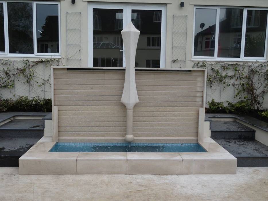 Stone sword floating before a water wall Barry Holdsworth Ltd