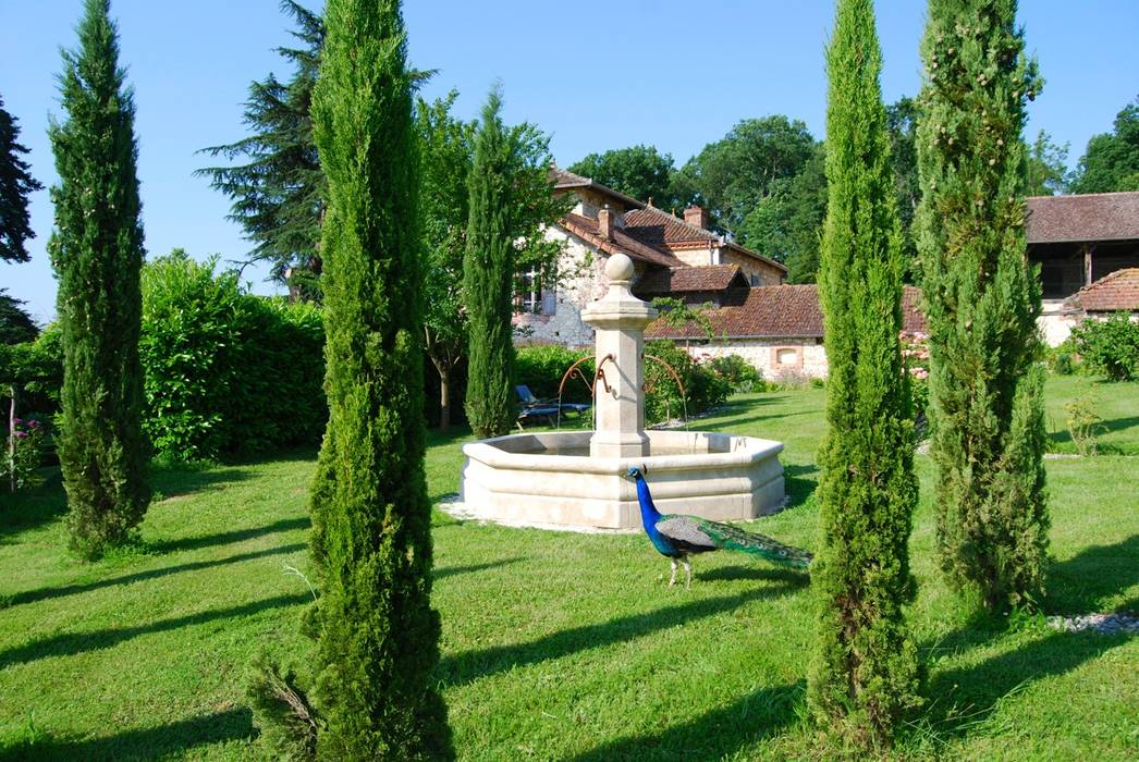 Fontaine centrale en pierre installée dans un jardin, Provence Retrouvée Provence Retrouvée Mediterranean style garden