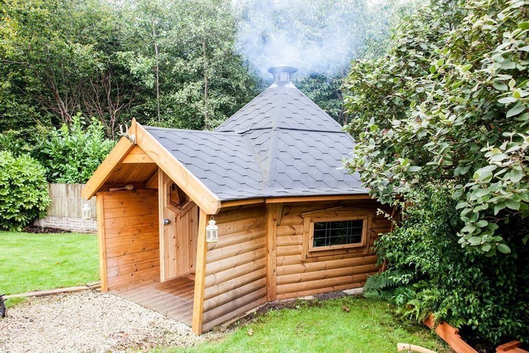A 10m² barbecue cabin with a short porch extension. Fire going well inside by the looks of it. Arctic Cabins Taman Gaya Skandinavia