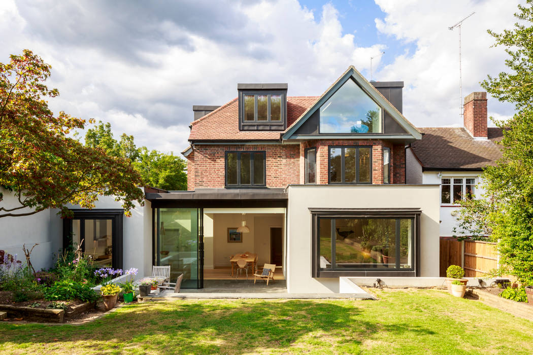 Rear view of extended and refurbished 1930s house in North London Jones Associates Architects منازل house extension, house refurbishment, modern extension, contemporary extension, house renovation, rear extension, roof extension, 1930s house, North London house extension, North London house refurbishment, Crouch End house extension, Crouch End house refurbishment, Crouch End house renovation, Crouch End house alterations, Crouch End architect, Muswell Hill house extension, Muswell Hill house refurbishment, Muswell Hill house renovation, Muswell Hill house alterations, Muswell Hill architect, N10 house extension, N10 house refurbishment, N10 house renovation, N10 house alterations, N10 architect, sliding glass doors, zinc roof, glass gable, zinc dormer