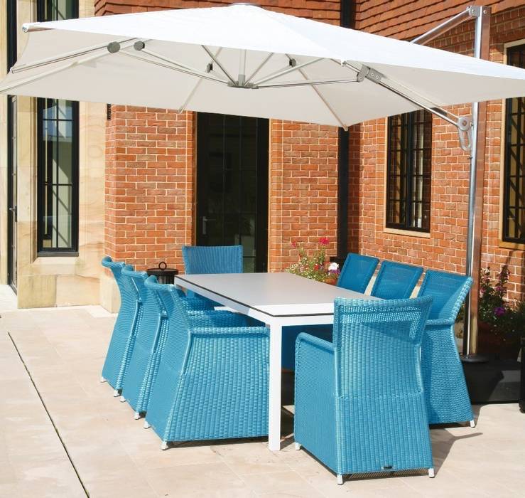 Rattan and Metal garden dining set with blue rattan armchairs and modern, white aluminium and glass table Ingarden Ltd Modern garden Furniture