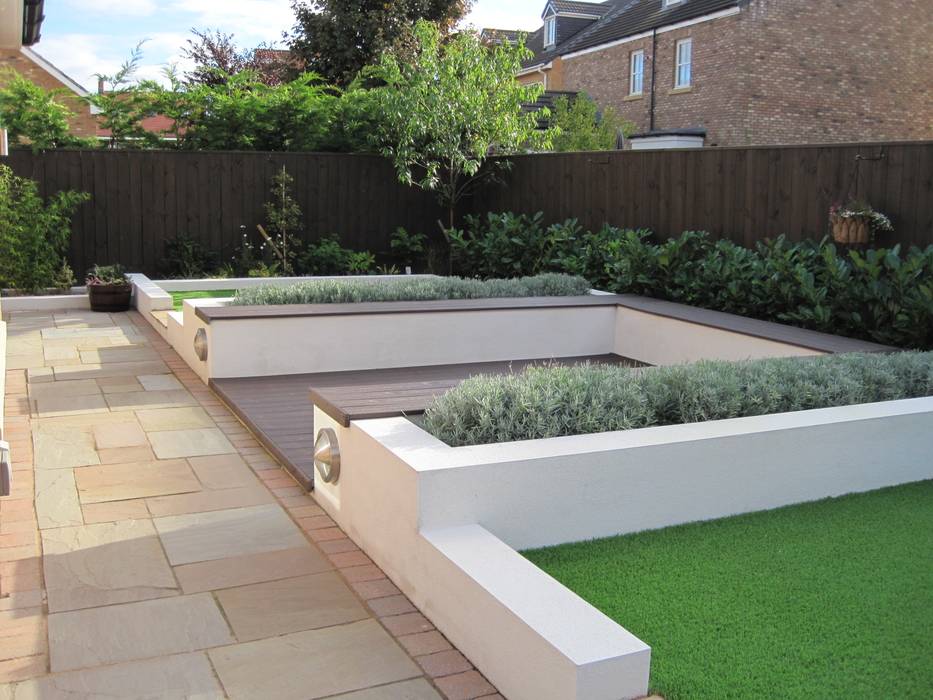 Contemporary rear garden with composite decking and artificial grass as view 1 but hedge more established Mike Bradley Garden Design