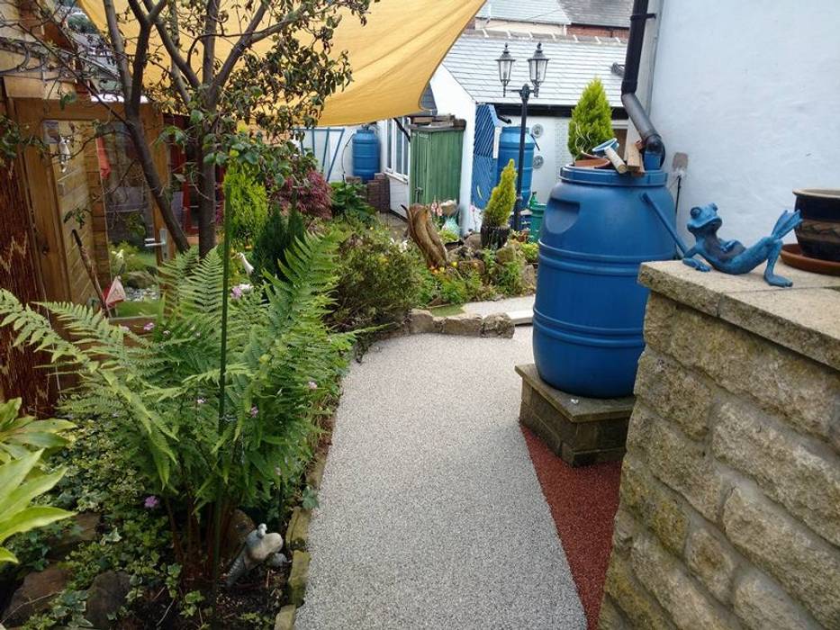 Resin bound paving installed over a concrete path creating more attractive surface. Permeable Paving Solutions UK Modern Garden Granite paving,gravel,garden,pathway,garden paths,surfacing