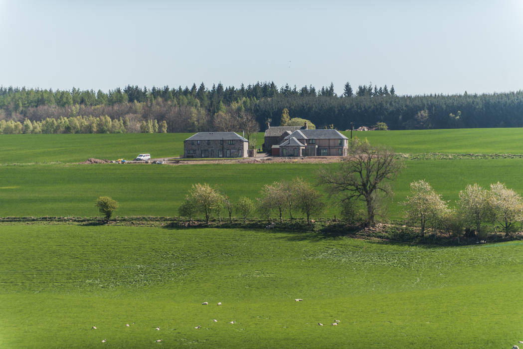 The development sits within the landscape as the former farm steading would Woodside Parker Kirk Architects Country style houses rural,architecture,farm steading,development,new build,new house,stone house,landscape,countryside,view