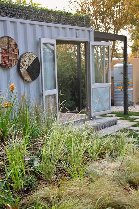 Container merging into the landscape Acton Gardens Industrial style houses container living,garden,pergola,grassland,plants,bug hotel,shipping container