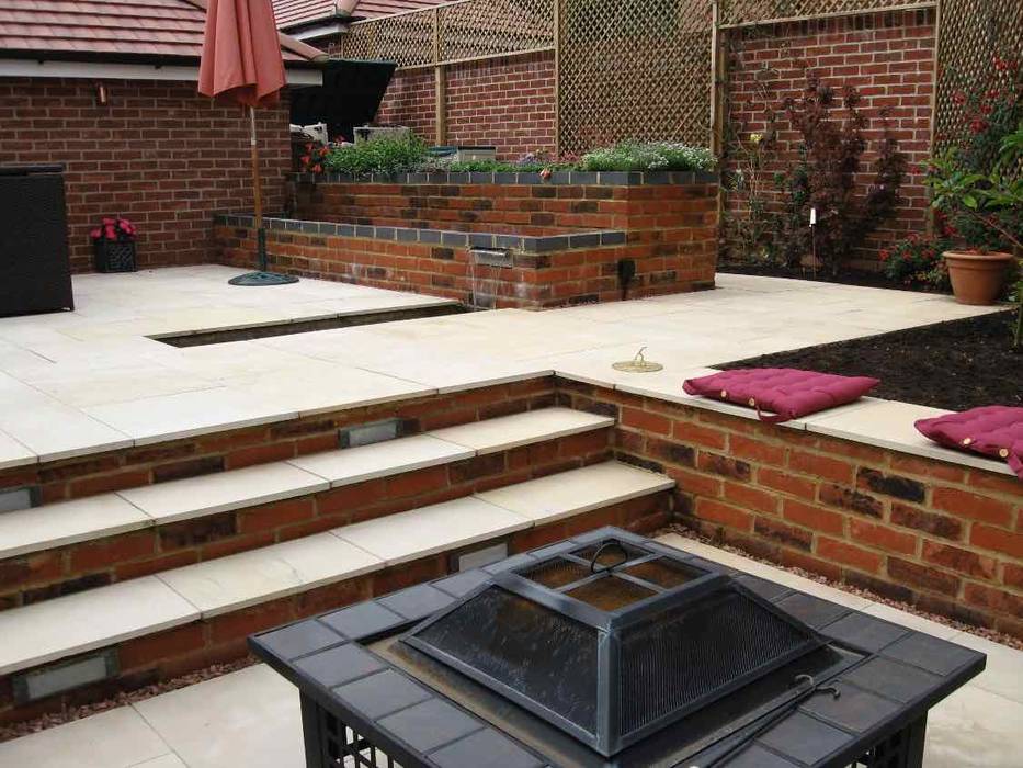 View from firepit to dining area Jane Harries Garden Designs Modern garden Stone