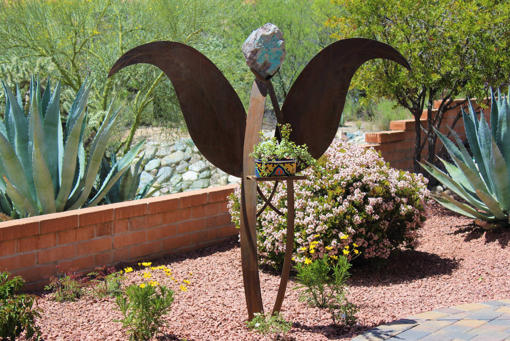 Iron Angel with an Arizona azurite rock D&V Landscaping Services LLC Modern Garden