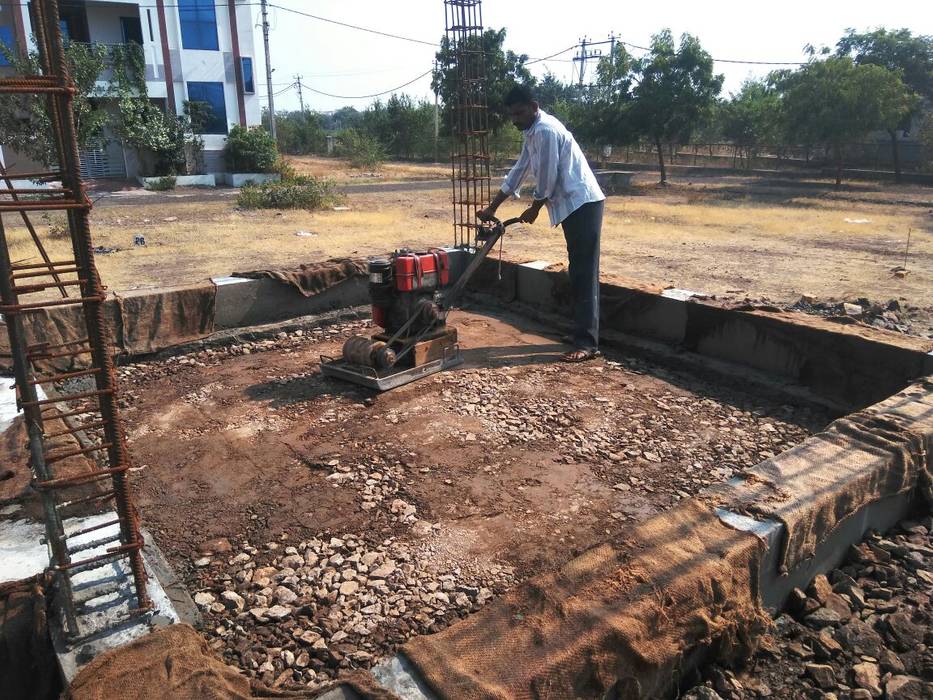 Earth soil compaction by Plate compactor Cfolios Design And Construction Solutions Pvt Ltd Multi-Family house