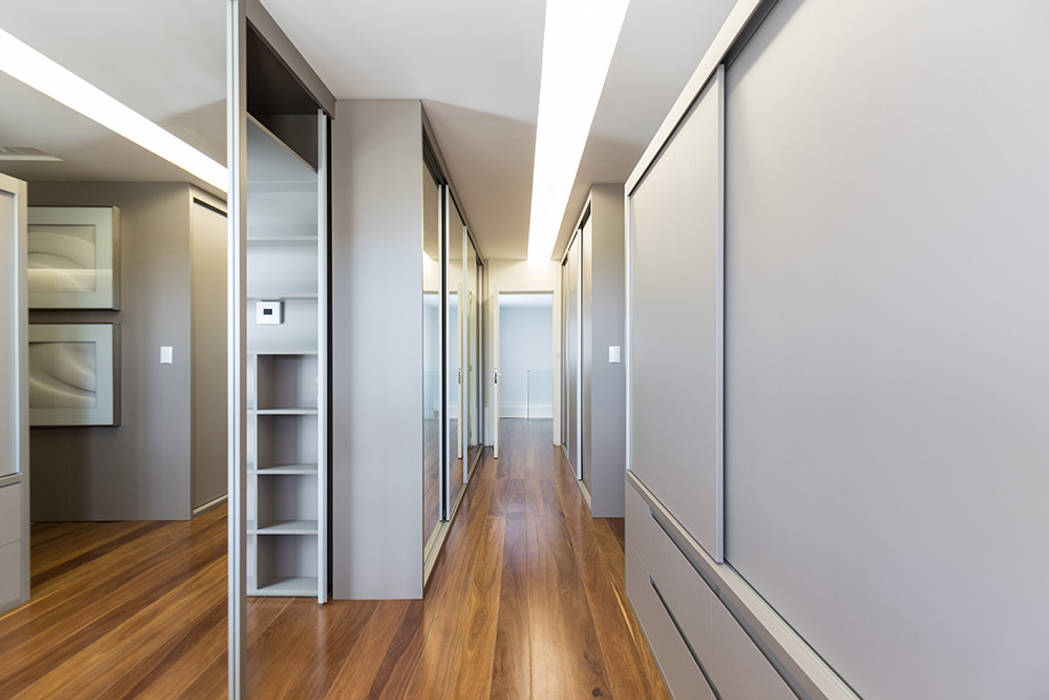 Iluminação linear Rabisco Arquitetura Closets MDF Suíte master casal, closet, closet espaçoso, marcenaria, acesso mimetizado, banheiro, mdf, sanca de iluminação, linearidade, piso de madeira, amadeirado