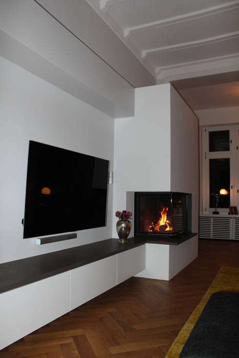 Moderner Eckkamin mit einer TV-Bank, Christoph Lüpken Ofenbau GmbH - Kamine aus Duesseldorf Christoph Lüpken Ofenbau GmbH - Kamine aus Duesseldorf Living room