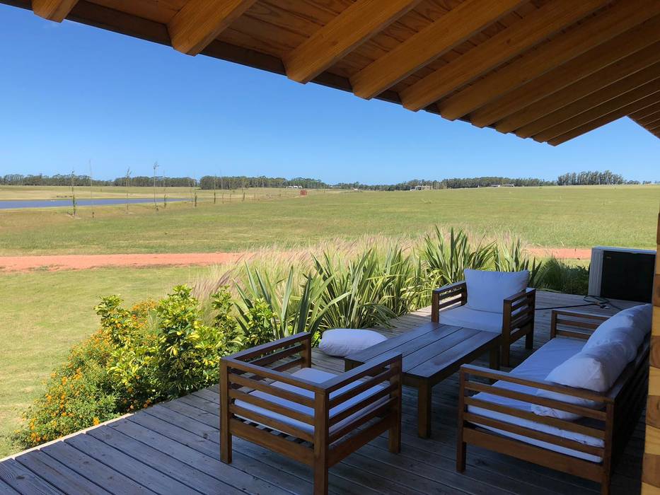 Proyecto Laguna de los Cisnes en Uruguay, Patagonia Log Homes - Arquitectos - Neuquén Patagonia Log Homes - Arquitectos - Neuquén Balcone, Veranda & Terrazza in stile rustico