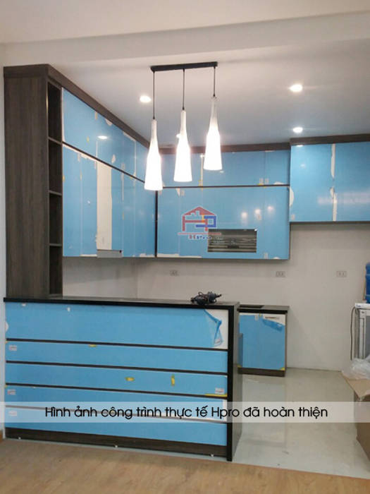 Ảnh thực tế tủ bếp acrylic chữ L kèm quầy bar nhà chị Hương ở Sơn La khi chưa gỡ lớp nilon bảo vệ Nội thất Hpro Nhà bếp phong cách hiện đại tủ bếp acrylic,tủ bếp acrylic giá,tủ bếp phủ acrylic,làm tủ bếp acrylic,