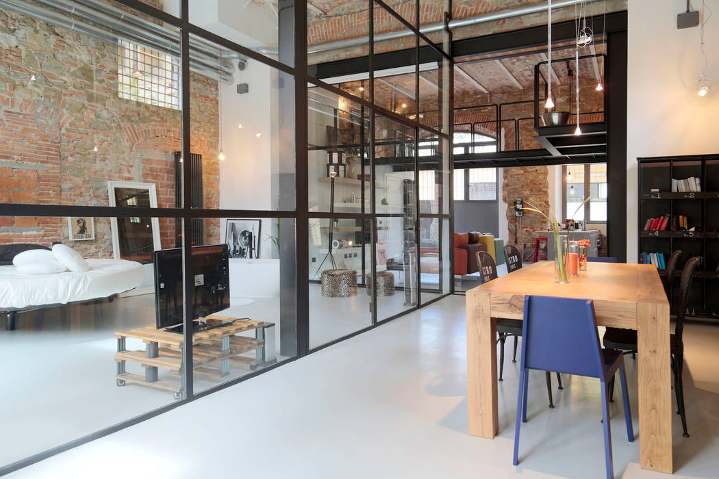 Sala da pranzo stile industrial con tavolo in legno Soffici e Galgani Architetti Sala da pranzo in stile industriale resina,legno,vetrata