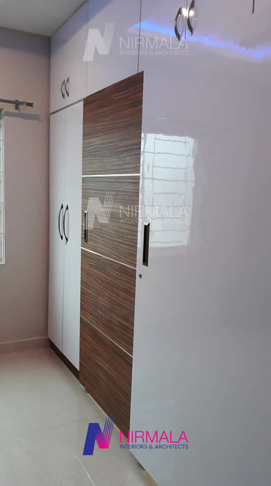 Interiors for 2 BHK at Vijaynagar Colony, Nirmala Architects & Interiors Nirmala Architects & Interiors Modern Bedroom Wardrobes & closets