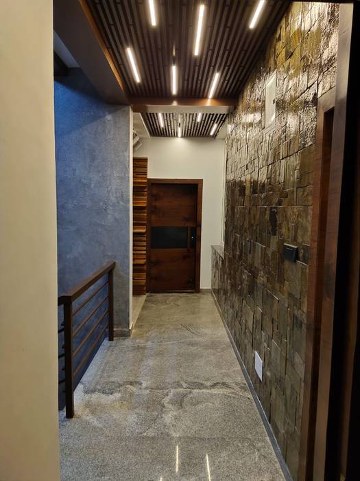 Hallway designed with stone cladding on wall and asymetric wooden ceiling with linear lighting Enwave Modern corridor, hallway & stairs