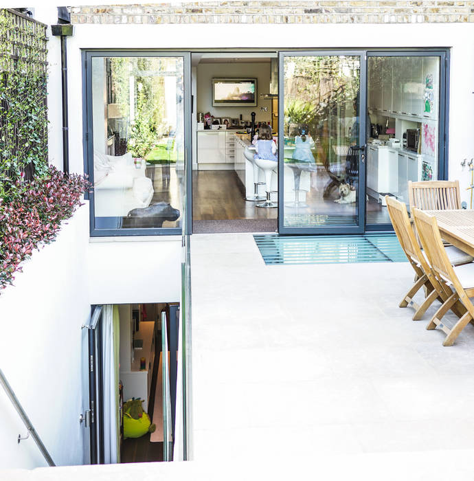 Bi-fold doors with access to patio area and rear basement staircase. Hatch Construction Ltd Modern houses Basement conversion London, Basement Construction London, London Basements, Basement conversion Clapham