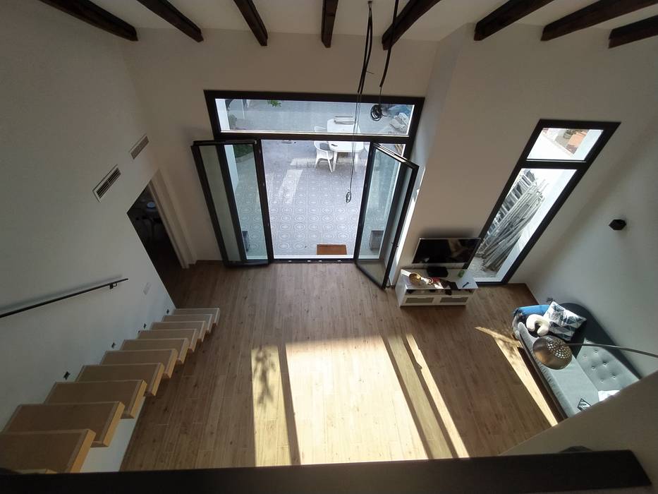 Vista interior: imagen del espacio a doble altura desde el piso superior OCTANS AECO Salas de estilo moderno