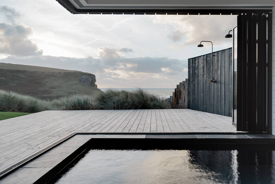 Inside Outside Swimming pool and decking. Arco2 Architecture Ltd Pool Eco friendly new build property in Cornwall. Mawgan Porth beach front property. Sustainably designed architecture.