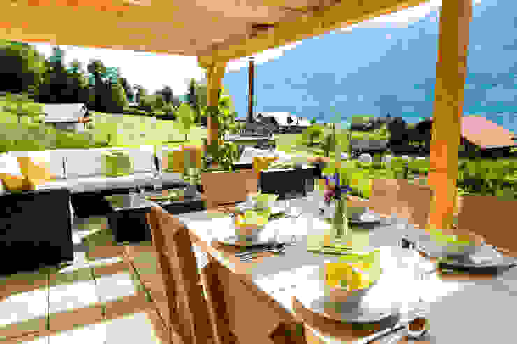 Gedeckte Terrasse mit Lounge und Esstischen Visions Haus Moderner Balkon, Veranda & Terrasse