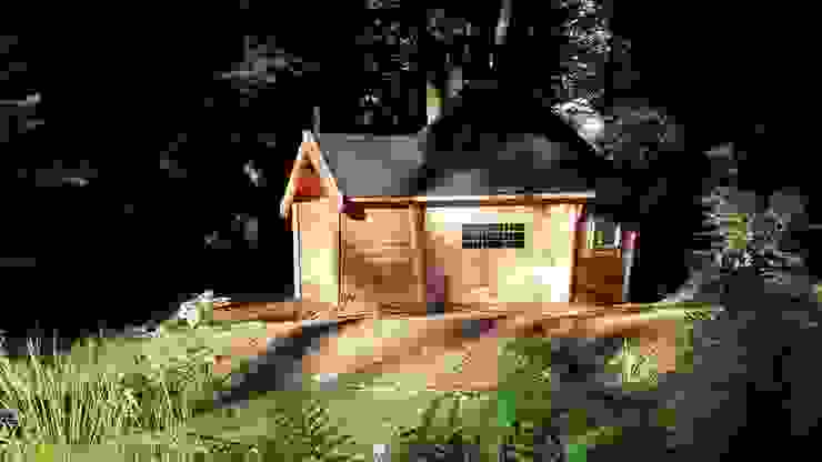 A cabin with a short porch extension by a lake in a woodland setting. Arctic Cabins Scandinavian style garden