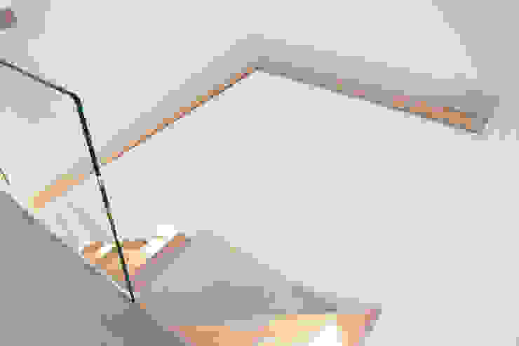 A Minimalist Floating Staircase With Oak Clad Treads And Glass