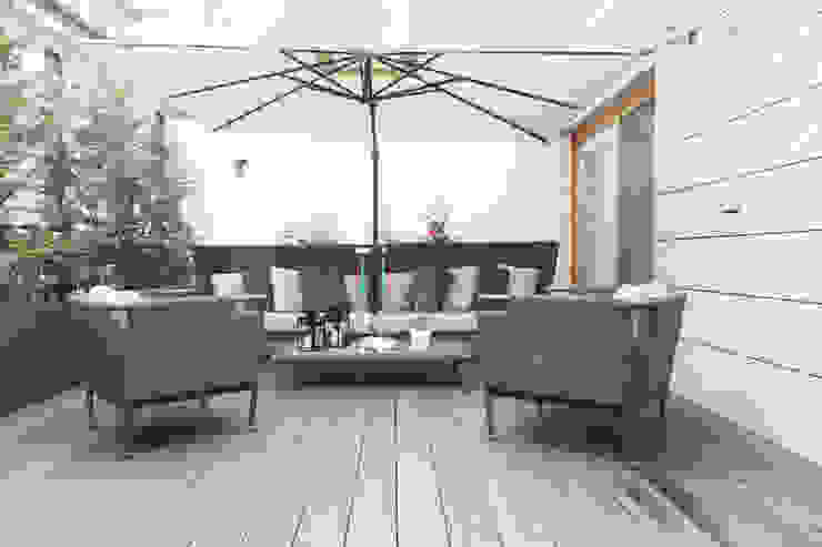 Terrazzo Filippo Colombetti, Architetto Balcone, Veranda & Terrazza in stile moderno Bianco Pergola a lamelle, terrazzo, facciata in ceppo, soggiorno esterno, decking grigio, siepe verde, serramenti in rovere.