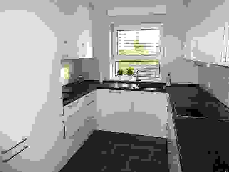 Junker Architekten Cucina moderna Cemento Bianco