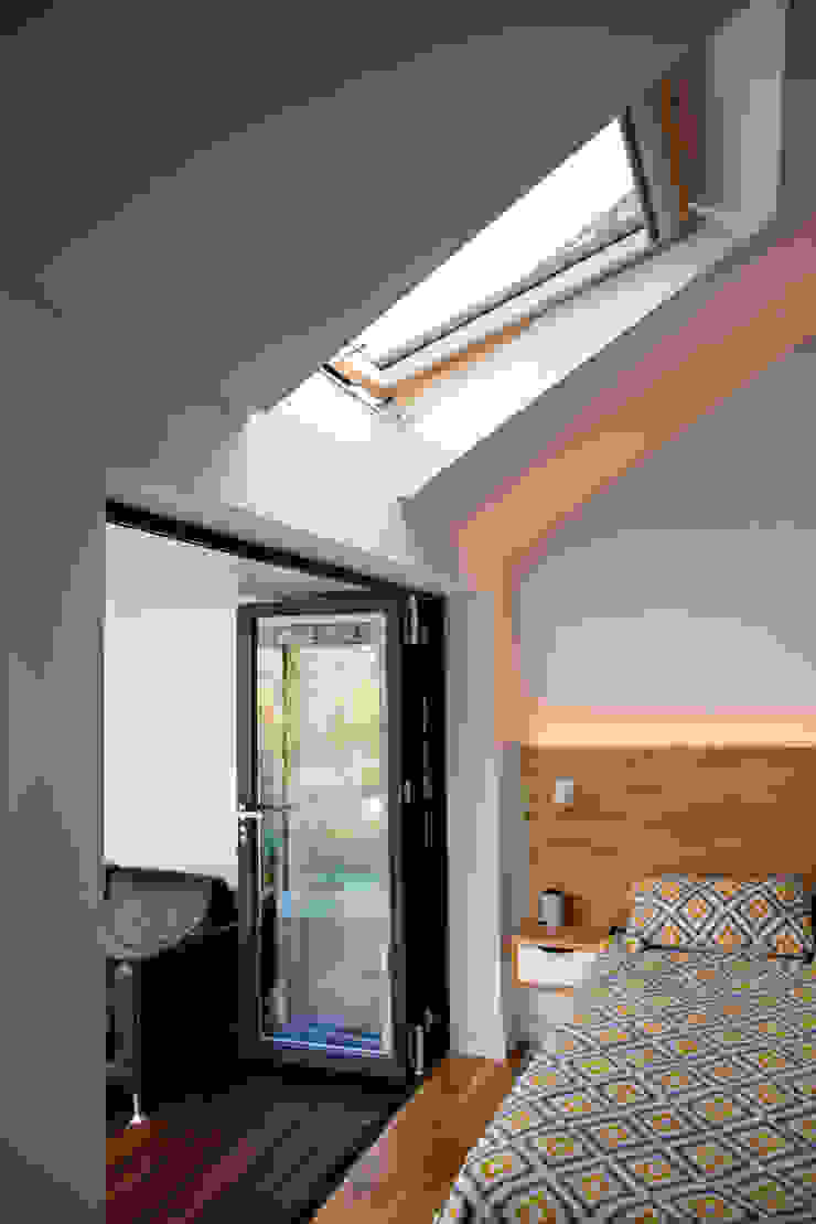 View of bi-folding doors and roof window in master bedroom dwell design ห้องนอน