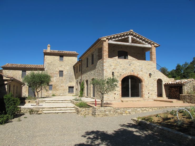 marco carlini architetto Country style houses Stone Amber/Gold