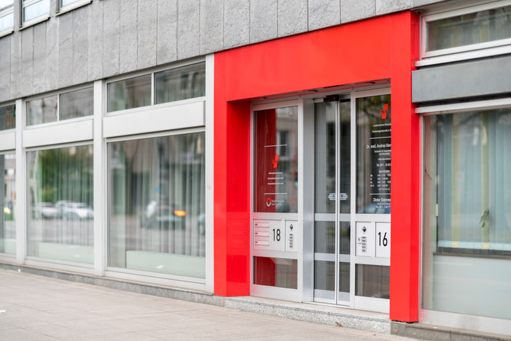Haupteingang in den typischen Farben Ohlde Interior Design Moderne Bürogebäude Aluminium/Zink Rot