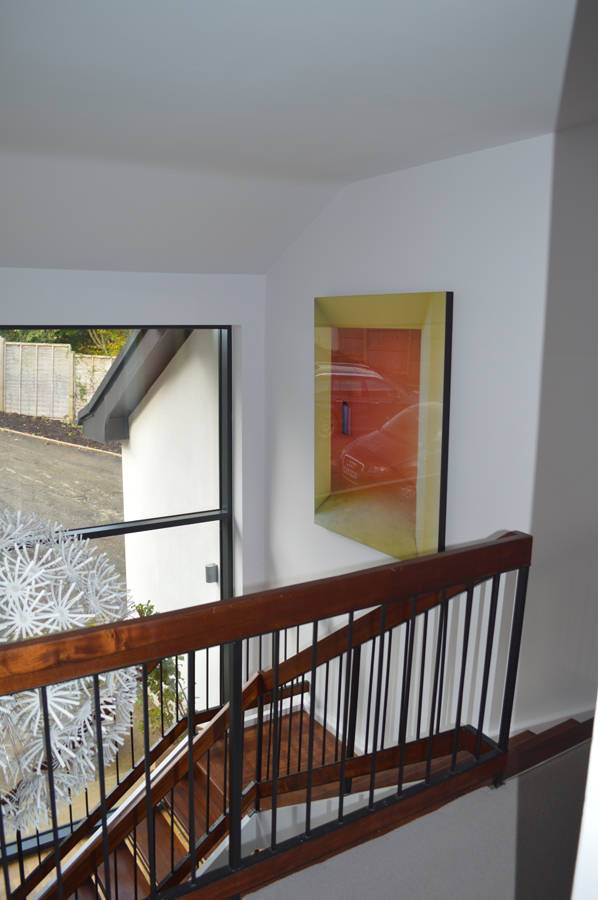 Double height hallway featuring a restored 1960s staircase