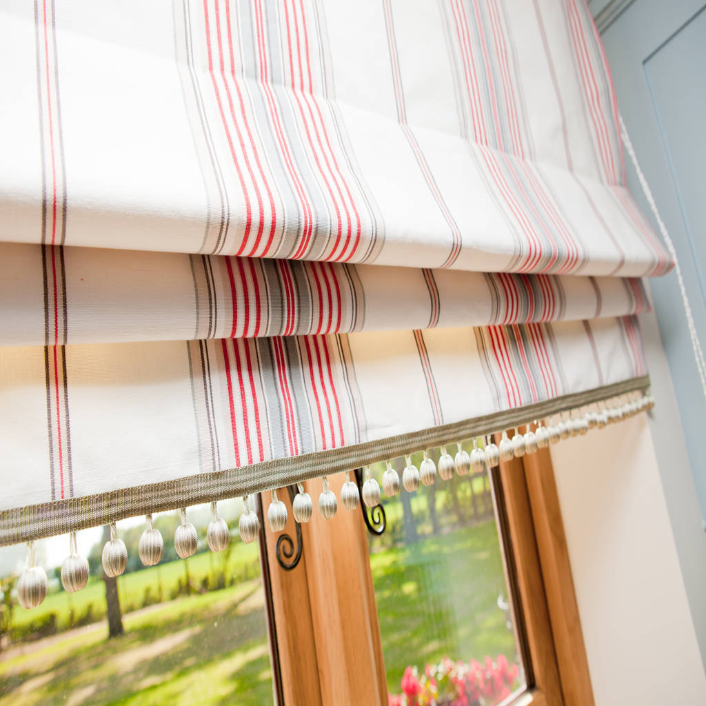 Ivory, taupe and coral red striped roman blinds with ball fringe design