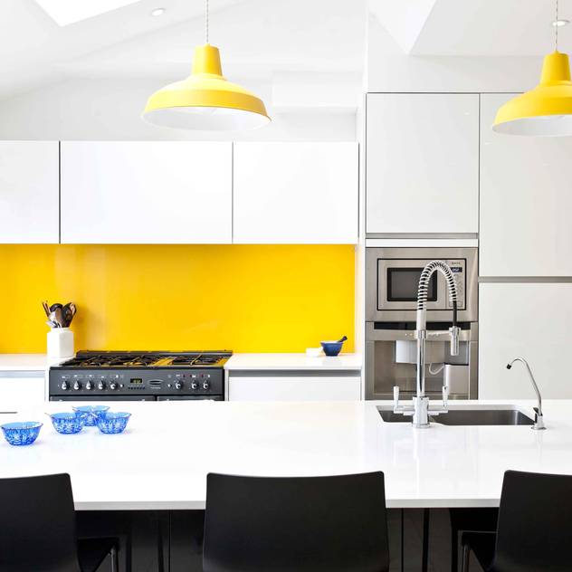 White, black, stainless steel and a vibrant splash of yellow.: modern Kitchen by Pyram